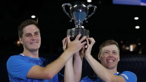 Henry Patten and Harri Heliovaara receive the Australian Open men's doubles trophy