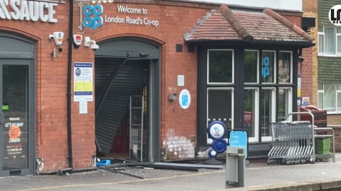 The smashed shutters at the front of a Co-op store
