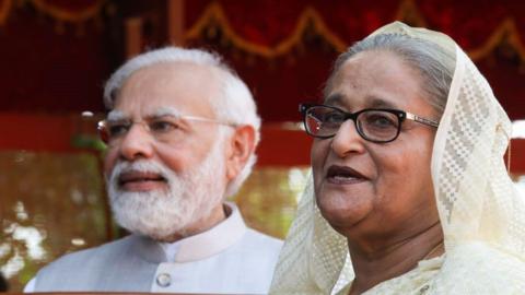 : Bangladesh Prime Minister Sheikh Hasina (R) speaks to the media during the ceremonial reception with Narendra Modi standing nearby at the Rashtrapati Bhavan in New Delh