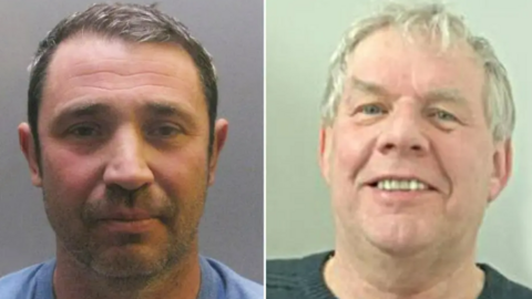 Craig Best, left, wears a blue shirt and has a short grey hair.  Roger Piling, right,  wears a black jumper and is smiling at the camera. He has short white hair.