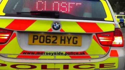 The rear of a liveried Mereyside Police car