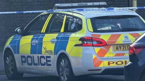 A police car blocking Ranelagh Road. Police tape can be seen behind