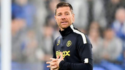 Xabi Alonso clasps his hand together during a Chelsea open training session