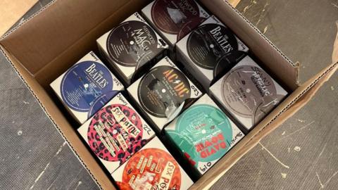 A close up of an opened box seized by police. Inside is counterfeit vinyl from bands including The Beatles, Fleetwood Mac and David Bowie.