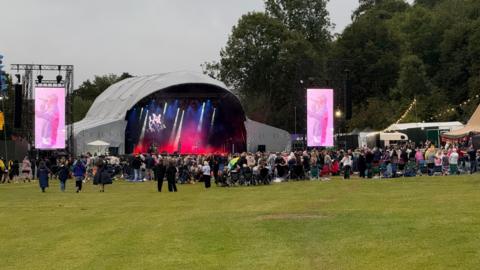 Small crowd at a concert with a stage in Darley Park