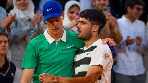 Jannik Sinner and Carlos Alcaraz hug after their French Open final in June 2025