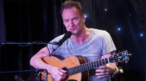 Sting performing with a guitar in 2017
