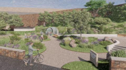 An illustrated picture of the proposed memorial garden. There are trees in the background, manicured gardens and pedestrians with walking and with bikes. 