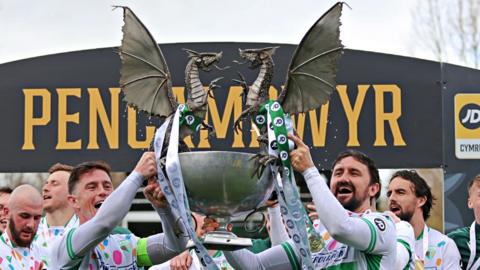 New Saints players Danny Redmond (left) and Ryan Brobbel hold up the Cymru Premier trophy