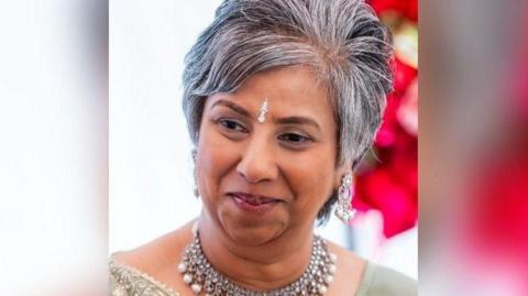 A head and shoulders picture of Nila Patel wearing silver jewellery round her neck and on the centre of her brow.
