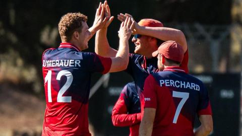 Jersey players celebrate a wicket