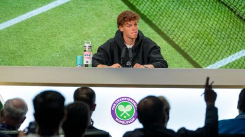 Jannik Sinner speaks at a news conference during the 2025 Wimbledon Championships