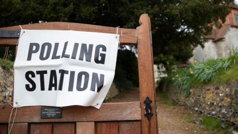 Picture shows a gate with a polling station sign
