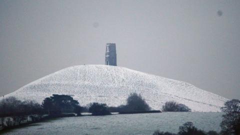 Snow surrounds Glastonbury Tor in Somerset