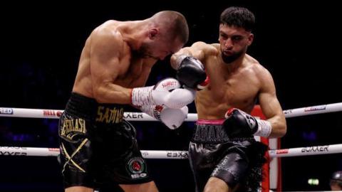 Adam Azim lands a punch on Sergey Lipinets