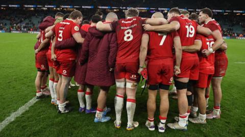 Wales players in a huddle after the 48-7 defeat against England 