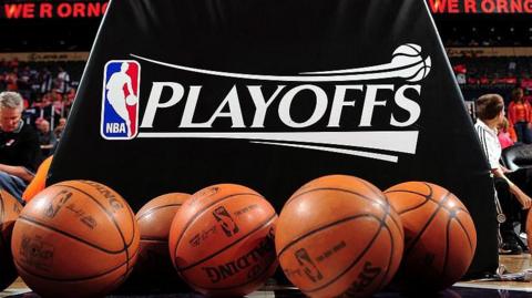 A logo of the NBA play-offs with multiple basketballs in shot at the bottom of the picture