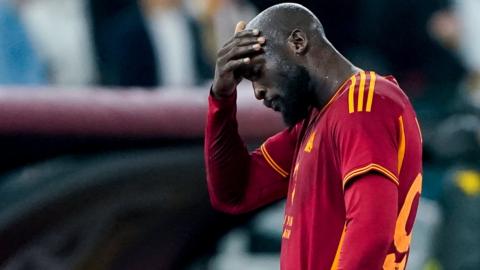 Romelu Lukaku puts his hand to his head after being sent off for Roma against Fiorentina