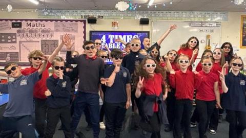 Children from Ecclesfield Primary School singing times tables to K-Pop songs wearing sunglasses.