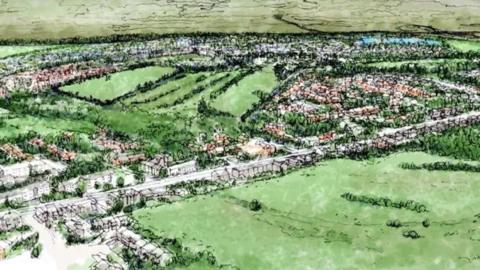 An artist's impression shows a long road and housing estate running through the middle of two green fields