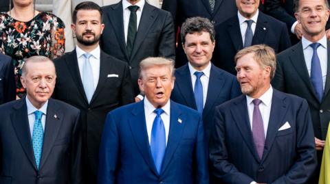 Donald Trump poses alongside other world leaders at a Nato summit. 