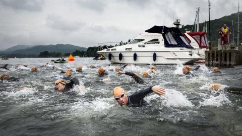 Swimmers take part in the Great North Swim on Lake Windermere in Cumbria