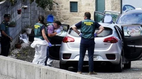 Officers inspect evidence at the scene of a triple murder in the area of Valga in Potevedra, Spain, 16 September 2019