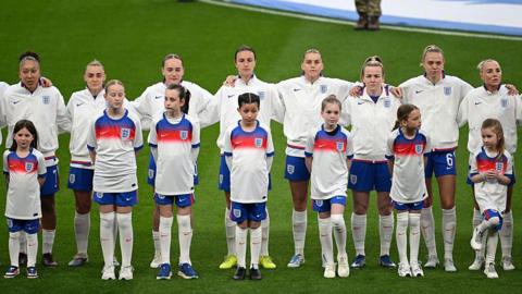 England women line up to sing the national anthem