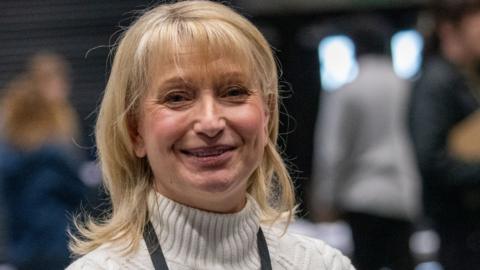Sian Astley, wearing a white woolly jumper