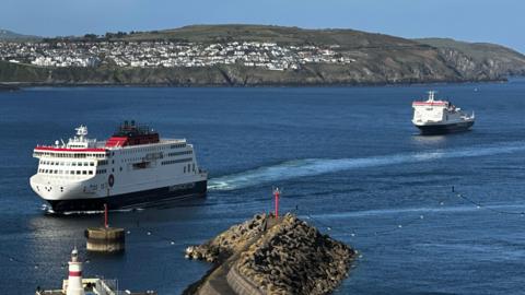 The Manxman ferry sailing into Douglas Harbour with the Ben-my-Chree in the bay behind. Onchan Head is in the background.