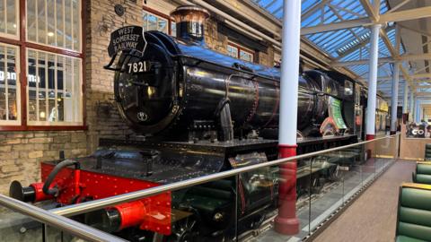 A steam engine on display inside a shopping centre