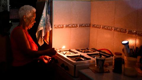 Gladys Valdes, 76, prepares coffee during a blackout as Cuba's national electric grid collapsed, according to the country's grid operator, leaving around 10 million people without power amid a U.S.-imposed oil blockade, in Havana, Cuba March 16, 2026.