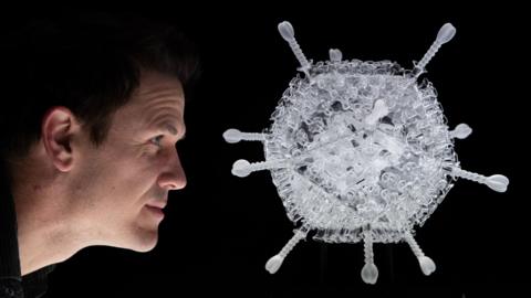 Luke Jerram with his sculpture of the AstraZeneca vaccine