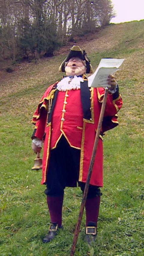 Man in traditional red outfit with black trousers.
