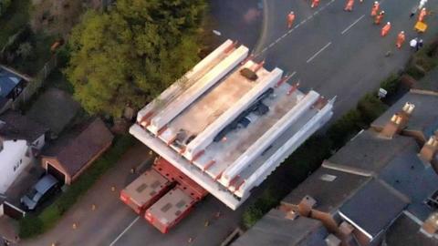 Huge railway bridge driven through residential streets