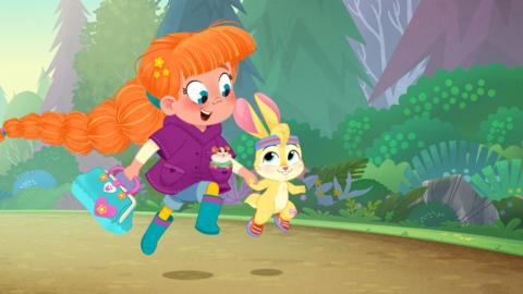 Vida the Vet skips along holding hands with a rabbit.