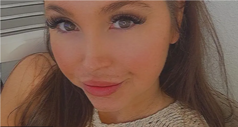 Smiling close-up selfie of Samantha Murphy. She has long brown hair and long eyelashes.