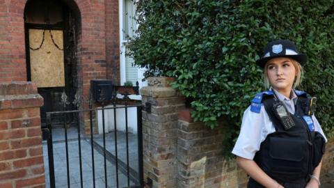 A police officer stands outside Britain's Prime Minister Keir Starmer's private home, after it was damaged by fire in a suspected arson attack in north London