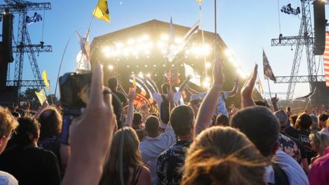 Festival goers watch Guns 'n' Roses perform