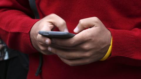 Man's hands with smartphone