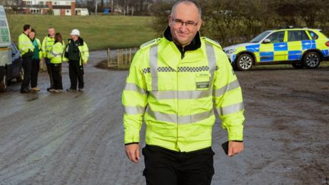 Dave Throup with police on a raid of an illegal waste site