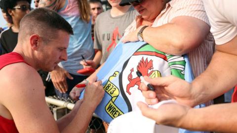 Paul Mullin signs autographs for fans at WakeMed Soccer Park