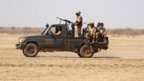 Burkina Faso soldiers patrol aboard a pick-up truck on the road from Dori to the Goudebo refugee camp, on February 3, 2020