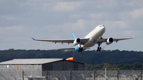A plane taking off with airport passengers at Gatwick Airport. 