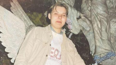 A photograph of Izabela Helena Zablocka wearing a white denim over shirt