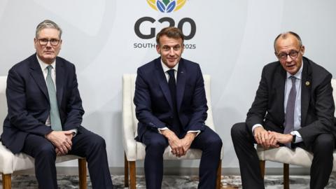 German Chancellor Friedrich Merz, French President Emmanuel Macron, Ukranian President Voloydmyr Zelensky, and British Prime Minister Keir Starmer sit next to one another.