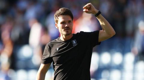Sheffield Wednesday head coach Danny Rohl clenching his left fist in the air.