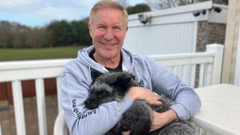 Les Hemstock holding Fern the American silver fox