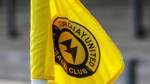 A corner flag showing Torquay United's badge 