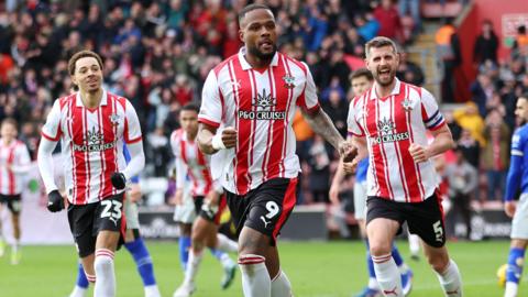 Cyle Larin runs off to celebrate after scoring against Watford